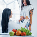 female-nutritionist-measuring-waist-of-patient-by-2025-03-18-19-47-32-utc_Easy-Resize.com